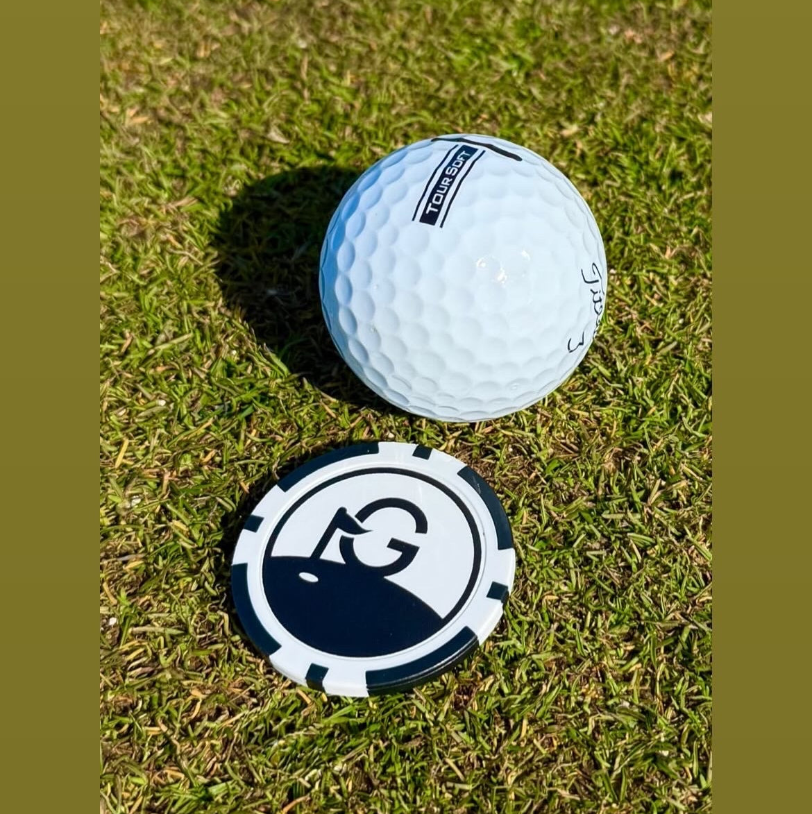 Golf ball on grass with a visible brand logo